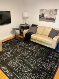 a living room with a couch and a table at North of Avon B&B Suites in Stratford