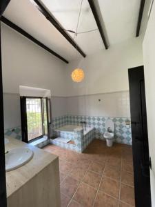 a bathroom with a sink and a toilet at Cortijo Andaluz Doña Adela in Almería