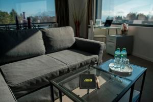 a living room with a couch and a glass table at Apart'Hotel 46a in Lausanne