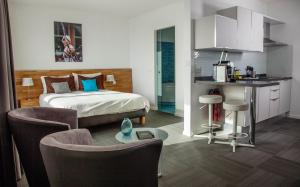 sypialnia z łóżkiem, stołem i krzesłami w obiekcie Apart'Hotel 46a w Lozannie