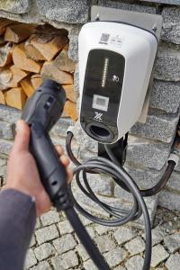 a person holding a hair dryer in front of a pay phone at Villa Bello in Berchtesgaden