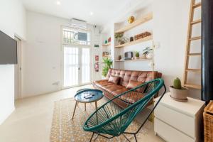 a living room with a couch and a table at 2 bedrooms 1 bathroom furnished - Lavapies - Modern Cozy - MintyStay in Madrid