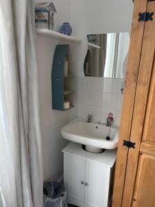 a bathroom with a sink and a mirror at Seascape guest house in Melcombe Regis