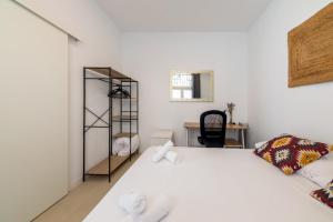 a bedroom with a white bed and a desk at 2 bedrooms 1 bathroom furnished - Lavapies - Modern Cozy - MintyStay in Madrid