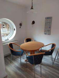 a table and chairs in a room with a table at Seeblick Wohnung 116 in Ostseebad Koserow