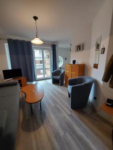 a living room with two couches and a table at Seeblick Wohnung 116 in Ostseebad Koserow