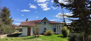 a small white house with a red roof at Pia's house garden in Campobasso