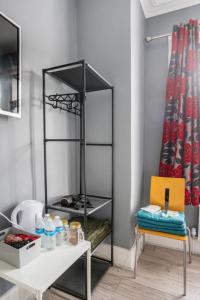 a black shelf in a room with a table and a chair at Hatton Homes - Tottenham Hotspurs Stadium in London