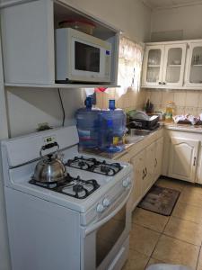 a kitchen with a stove with a tea pot on it at Bed and Breakfast in Providence