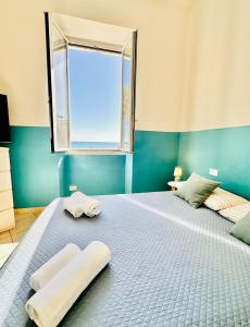 En eller flere senge i et værelse på Hostdomus - Sea and Sand Suite