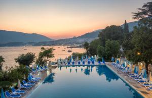 a view of a pool with chairs and water at Hunguest Hotel Sun Resort in Herceg-Novi