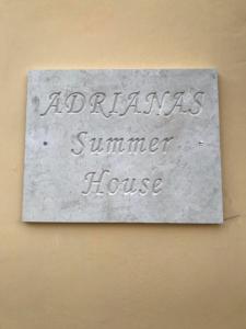 a sign that says apartments summer house on a wall at Adriana's Summer House in Kassiopi