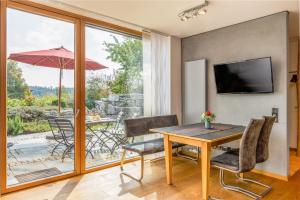 a dining room with a table and chairs and a patio at Ferienwohnung Wellvital in Bad Endorf