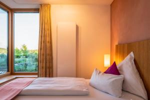 Schlafzimmer mit einem Bett und einem großen Fenster in der Unterkunft Ferienwohnung Rosengarten in Bad Endorf