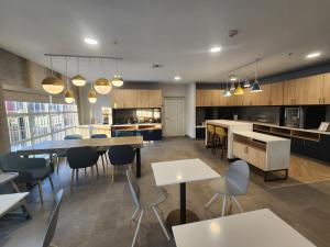 a large kitchen and dining room with tables and chairs at TownePlace Suites by Marriott Killeen in Killeen