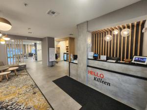 a lobby with a hello kitchen sign on the wall at TownePlace Suites by Marriott Killeen in Killeen