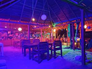 a dining room with tables and chairs and lights at The beach lovers nilaveli in Nilaveli