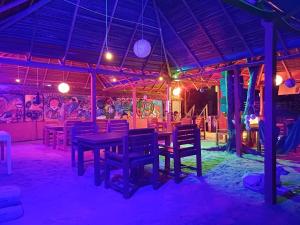 a dining room with a table and chairs and graffiti at The beach lovers nilaveli in Nilaveli