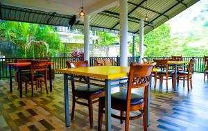 a restaurant with tables and chairs on a patio at Ella Chalana Dew In in Ella