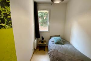 a small bedroom with a bed and a window at Les Naïades J60 - 2 bedrooms for 5 people ! in Avène