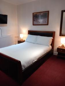 a bedroom with a large bed with two night stands at Number Five in Brighton & Hove
