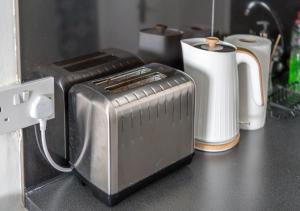 a toaster sitting on a counter next to a mug at Private Studio Unit in Chapel Market London in London