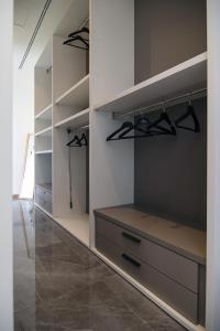 um closet com gavetas e prateleiras em Gigi Suites&Apartments em Stresa