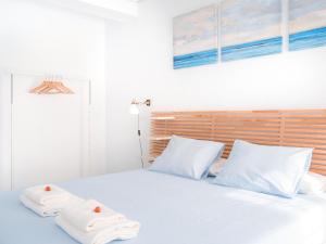a bedroom with a bed with two towels on it at Riverside Apartment in Triana in Seville