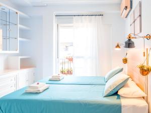a bedroom with two beds and a window at Riverside Apartment in Triana in Seville