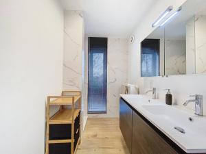 a bathroom with a sink and a mirror at Duplex - Appartement 'Tijl Uilenspiegel' - Oostduinkerke in Oostduinkerke +9 photos