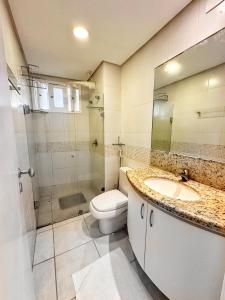 a bathroom with a toilet and a sink and a shower at Residence Vespucci in Natal