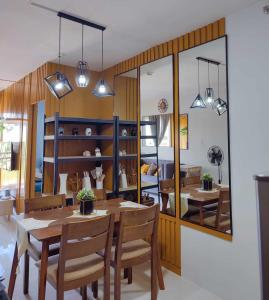a dining room with a table and chairs and a mirror at Palawan Paradise Condotel Building 2 3S in Puerto Princesa City