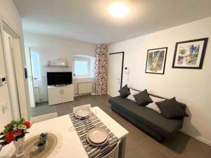 a living room with a couch and a table at Scala Santa Apartment in Trieste