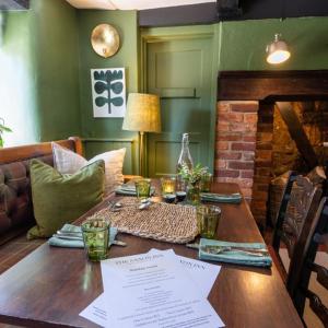 a wooden table in a living room with a couch at The Saxon Inn in Blandford Forum
