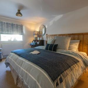 a bedroom with a large bed and a window at The Saxon Inn in Blandford Forum
