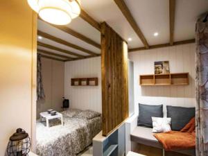 a bedroom with a bed and a table in it at Camping Les Perouses in Saint-Clément-des-Baleines