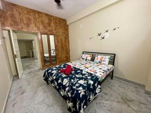 a bedroom with a bed in a room with birds on the wall at Beautiful 3bhk at Hitechcity in Kondapur