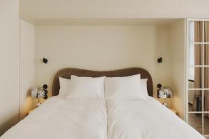 A bed or beds in a room at Hotel Bella Grande