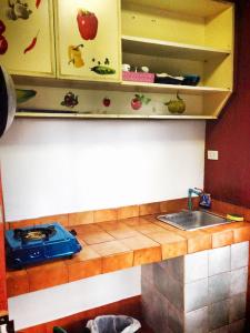 a kitchen with a sink and a counter top at Utopia House Phangan in Mae Haad