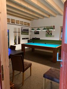a room with a pool table and chairs at Enkelburg in Saal