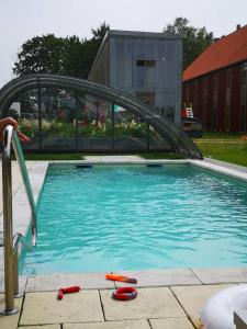 a swimming pool with a bridge over the water at Enkelburg in Saal