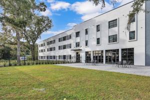 a white building with tables and chairs in a yard at The Well #209 Apartment in Zephyrhills