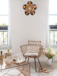 a living room with a chair and a table at Hôtel Henriette in Paris +43 photos