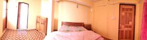 Postel nebo postele na pokoji v ubytování Sunrise Homestay
