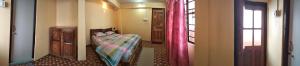 Postel nebo postele na pokoji v ubytování Sunrise Homestay