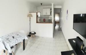 Habitación blanca con mesa y cocina en Exelente Departamento en La Plata
