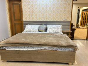 a large bed with two pillows on top of it at 3-Bedrooms Luxury Apartment in Lahore