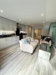 a living room with a couch and a kitchen at Mary McGill’s in Ballycastle