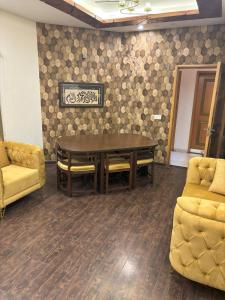 a conference room with a table and two chairs at 3-Bedrooms Luxury Apartment in Lahore