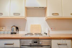 a kitchen with a stove and a counter top at Blackthorn in Bury Saint Edmunds